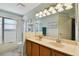 Bathroom with double sinks, granite countertops, a tub with shower and light-filled at 20145 Bay Cedar Ave, Tampa, FL 33647