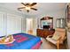 Spacious bedroom with a ceiling fan, large dresser, and plenty of natural light at 20145 Bay Cedar Ave, Tampa, FL 33647