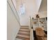 Staircase with white railings leading up to the second story of the home, featuring unique decor accents at 20145 Bay Cedar Ave, Tampa, FL 33647