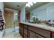 Bathroom featuring a large vanity, dual sinks, and a glass-enclosed shower at 2153 Broadway View Ave, Brandon, FL 33510