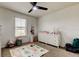 Bright bedroom with a ceiling fan, a changing table, and a play area for children at 2153 Broadway View Ave, Brandon, FL 33510