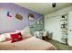Stylish bedroom featuring a study area, decorative shelves, and eye-catching wall decor at 2153 Broadway View Ave, Brandon, FL 33510
