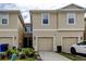 Inviting townhome with a beige exterior, two-car garage, and manicured landscaping in a desirable neighborhood at 2153 Broadway View Ave, Brandon, FL 33510