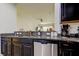 Modern kitchen featuring black cabinets, granite countertops, and stainless steel appliances for stylish cooking at 2153 Broadway View Ave, Brandon, FL 33510