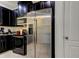 Modern kitchen boasts stainless steel appliances, dark cabinets, granite counters, and stylish tile flooring at 2153 Broadway View Ave, Brandon, FL 33510