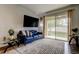 Cozy living room with sliding glass doors to patio, large tv, and neutral paint at 2153 Broadway View Ave, Brandon, FL 33510
