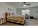 Inviting main bedroom with a rustic wooden bed frame and a ceiling fan at 2153 Broadway View Ave, Brandon, FL 33510