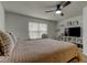 Comfortable bedroom with a wooden bed, ceiling fan, and media center at 2153 Broadway View Ave, Brandon, FL 33510
