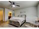 Bright bedroom featuring a wooden bed frame, adjoining bathroom and modern decor at 2153 Broadway View Ave, Brandon, FL 33510