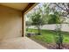 Outdoor patio with a view of a fenced-in backyard, featuring lush greenery and shade trees at 2153 Broadway View Ave, Brandon, FL 33510