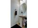 Charming powder room with pedestal sink, oval mirror, and tiled floors at 2153 Broadway View Ave, Brandon, FL 33510