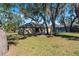 Large backyard with mature trees offering ample shade at 2156 Deltona Blvd, Spring Hill, FL 34606