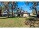 Backyard featuring a well-maintained lawn and mature trees at 2156 Deltona Blvd, Spring Hill, FL 34606