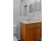 Bathroom vanity features a wood cabinet, neutral countertop, and large mirror at 2156 Deltona Blvd, Spring Hill, FL 34606