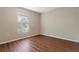 Bedroom with wood-look flooring, neutral paint, and window at 2156 Deltona Blvd, Spring Hill, FL 34606