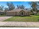 Charming single-story home with an attached two-car garage and a well-maintained front lawn at 2156 Deltona Blvd, Spring Hill, FL 34606