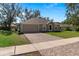 Inviting single-story home with brick-paved driveway and attached two-car garage at 2156 Deltona Blvd, Spring Hill, FL 34606