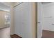 Hallway with closet and bathroom doors, wood-look flooring and neutral paint at 2156 Deltona Blvd, Spring Hill, FL 34606