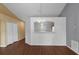 Spacious living area features wood-look flooring, fresh paint, and an elegant chandelier at 2156 Deltona Blvd, Spring Hill, FL 34606