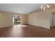 Open-concept living room with sliding glass doors to the backyard and laminate flooring at 2156 Deltona Blvd, Spring Hill, FL 34606