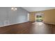 Bright living room with laminate flooring, vaulted ceiling, and sliding glass door at 2156 Deltona Blvd, Spring Hill, FL 34606
