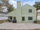 Rear view of the home featuring a patio, grill, and a well-maintained yard at 24510 Mason Ct, Lutz, FL 33559