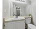 Bathroom with white vanity, large mirror, and toilet at 24510 Mason Ct, Lutz, FL 33559