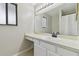 Bright bathroom featuring a large mirror, vanity with storage, and shower with curtain at 24510 Mason Ct, Lutz, FL 33559