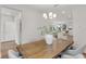 Open dining area featuring modern chandelier, a wooden table and view to kitchen at 2607 N 21St St, Tampa, FL 33605