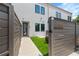Modern townhome featuring an artificial grass lawn, and wooden fence for curb appeal and privacy at 2808 N Florida Ave, Tampa, FL 33602