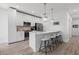 Bright kitchen featuring white cabinets, quartz countertops, stainless steel appliances, and a breakfast bar at 2808 N Florida Ave, Tampa, FL 33602
