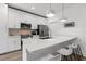 Bright kitchen featuring white cabinets, quartz countertops, stainless steel appliances, and a breakfast bar at 2808 N Florida Ave, Tampa, FL 33602