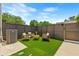 A private fenced patio with artificial grass, modern furniture, and an air conditioning unit at 2808 N Florida Ave, Tampa, FL 33602