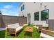 Back patio with comfortable seating, privacy fence, and artificial grass for a low-maintenance outdoor area at 2808 N Florida Ave, Tampa, FL 33602