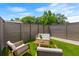 Cozy fenced patio featuring modern outdoor seating and a well-manicured artificial turf lawn at 2808 N Florida Ave, Tampa, FL 33602