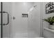 Modern bathroom shower featuring sleek white tile with mounted dispenser and glass door at 2808 N Florida Ave, Tampa, FL 33602