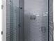 Modern bathroom shower featuring sleek gray tile and glass door with mounted dispenser at 2808 N Florida Ave, Tampa, FL 33602