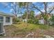 A spacious backyard featuring mature trees and lush green landscaping, with a white fence at 309 84Th Ne Ave, St Petersburg, FL 33702