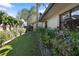 A well-maintained backyard with a lush lawn, privacy fence, and manicured shrubbery at 3416 Fairfield Trl, Clearwater, FL 33761