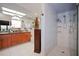 Bright bathroom featuring double sinks, walk-in shower, and skylight at 3416 Fairfield Trl, Clearwater, FL 33761