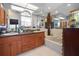 Well-lit bathroom featuring double sinks, granite counters and a sky light at 3416 Fairfield Trl, Clearwater, FL 33761