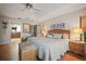 Well-lit bedroom features wood floors and door to en suite bathroom at 3416 Fairfield Trl, Clearwater, FL 33761