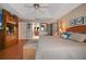 Well-lit bedroom with wood floors and door to en suite bathroom at 3416 Fairfield Trl, Clearwater, FL 33761