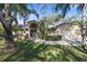 Charming home with lush landscaping, mature palms, and a welcoming entryway at 3416 Fairfield Trl, Clearwater, FL 33761