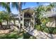 Inviting entrance with stone accents, arched window, and well-maintained landscaping at 3416 Fairfield Trl, Clearwater, FL 33761