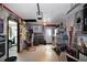 Spacious garage featuring an epoxy floor, extensive wall decor, work area, and a door leading to the driveway at 3416 Fairfield Trl, Clearwater, FL 33761