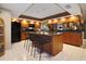 Spacious kitchen with a large island, wooden cabinets, and modern appliances at 3416 Fairfield Trl, Clearwater, FL 33761