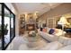 Bright living room showing the stone fireplace, vaulted ceilings, tile floors and view of the outdoor space at 3416 Fairfield Trl, Clearwater, FL 33761
