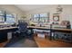 Bright office with dual workstations, laminate floors, natural light, and storage, great for a home-based business at 3416 Fairfield Trl, Clearwater, FL 33761