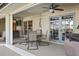An inviting covered patio featuring outdoor seating and views of the surrounding landscape at 3416 Fairfield Trl, Clearwater, FL 33761